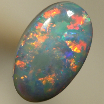SOLID SEMI BLACK OPAL Rolling flashes of red and yellow over turquoise blue